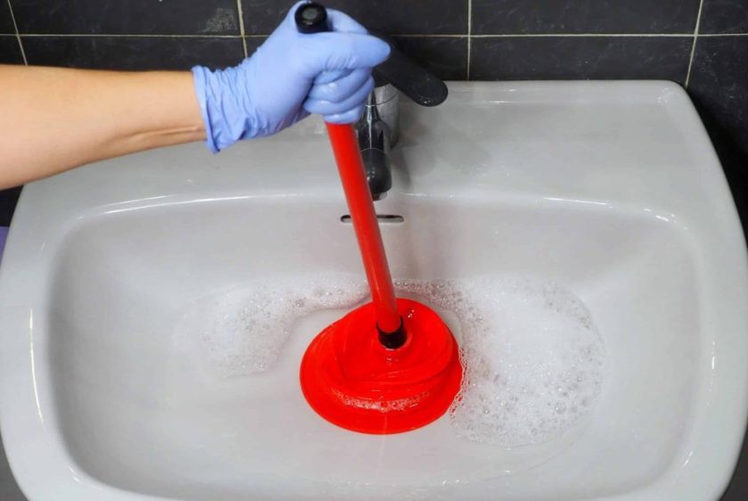 cleaning clogged pipes with a plunger